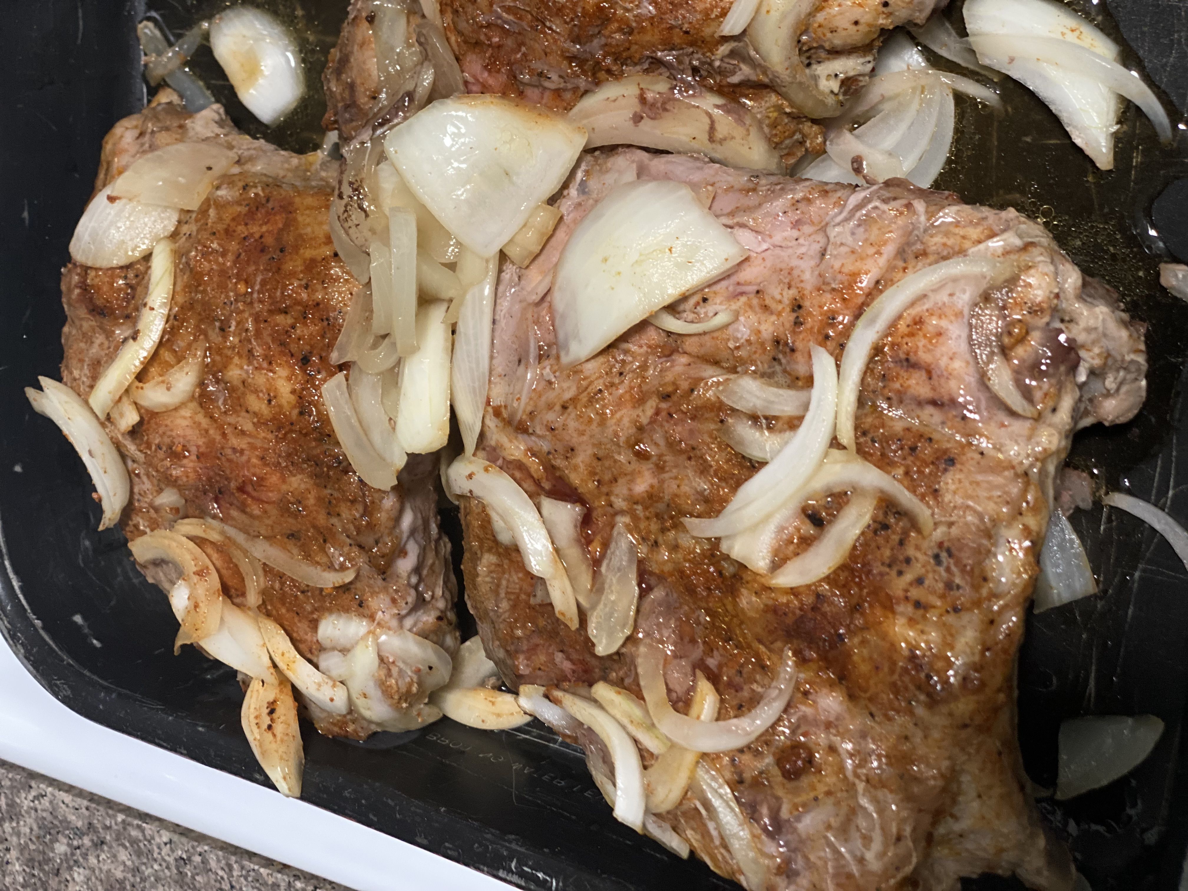 Ribs out of the foil wrapping after baking, in a pan